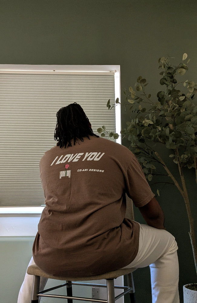 Our model is 6'3 “and wears a size 2XL shirt in the espresso variation of the Whispered “I Love You” tee!